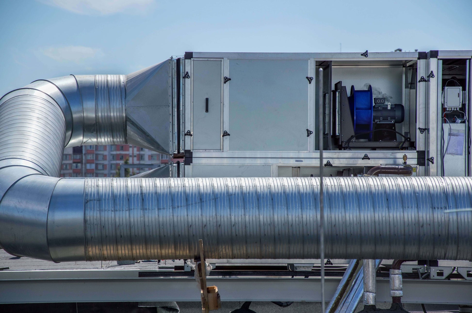 Air handler system on a rooftop showing maintenance access and ductwork.