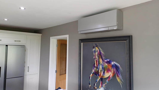 Modern air conditioning unit installed in a stylish home interior with a colorful horse painting on the wall.